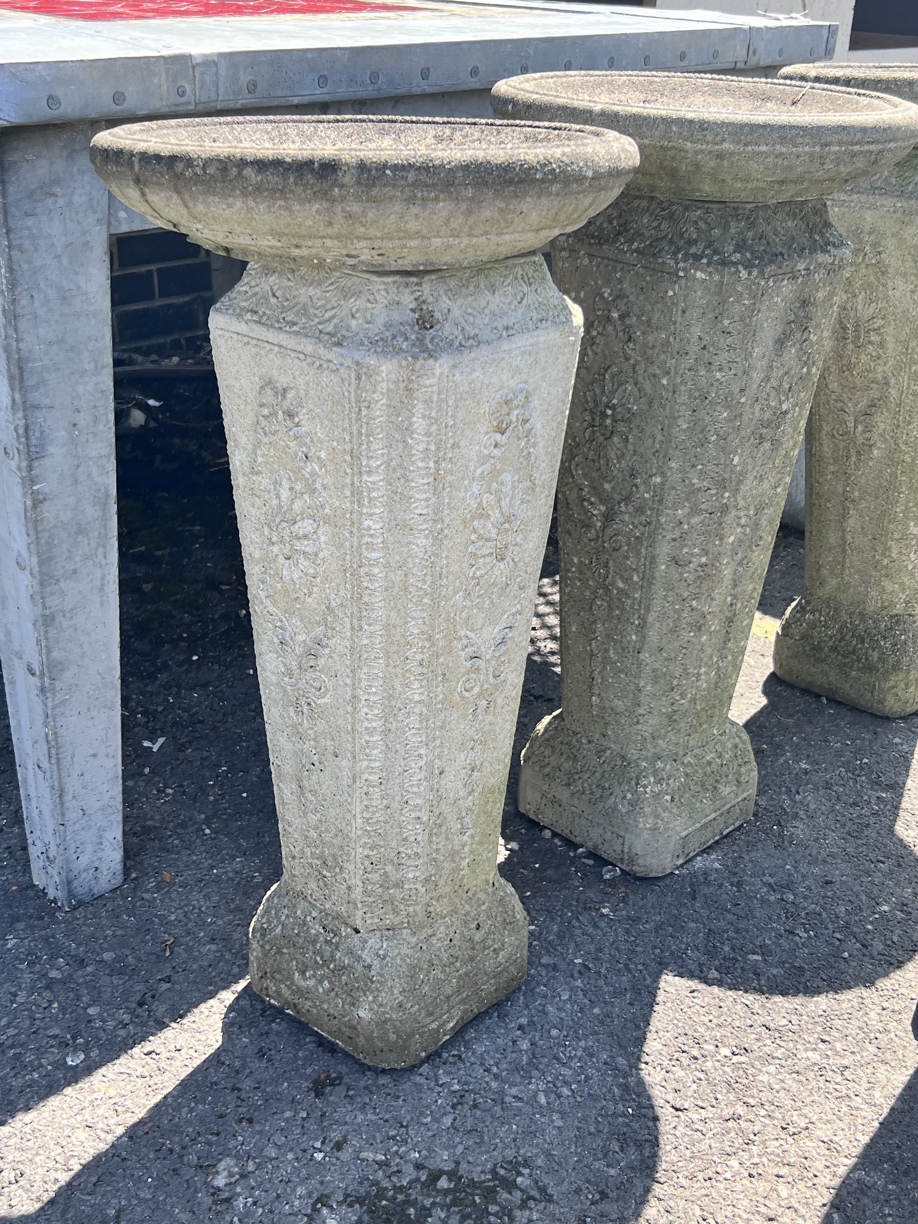 A set of four reconstituted stone circular bird baths, height 74cm